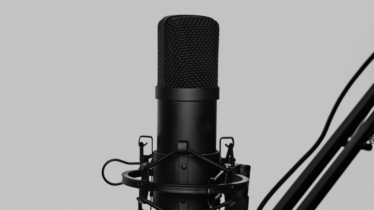 Micrófono de condensador negro con soporte antivibración en un brazo articulado para grabar podcasts